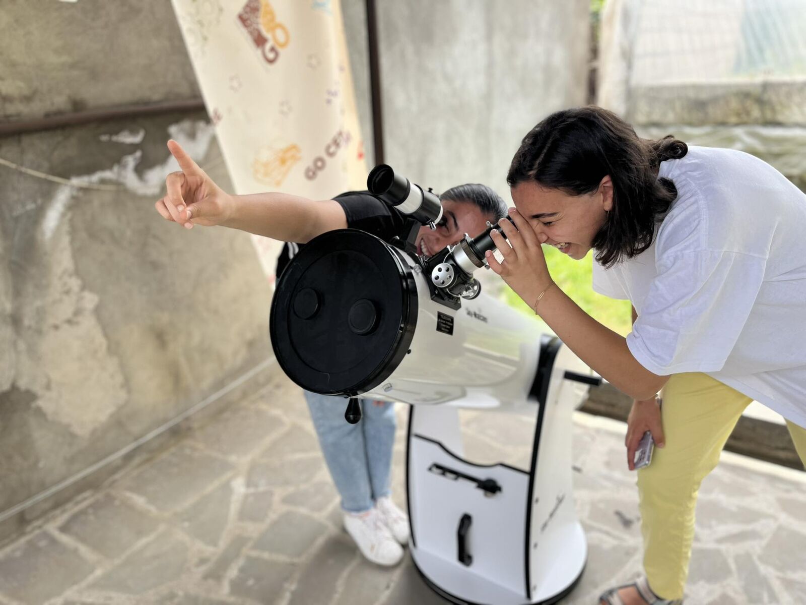 A camper at the GO summer camp looking through a telescope