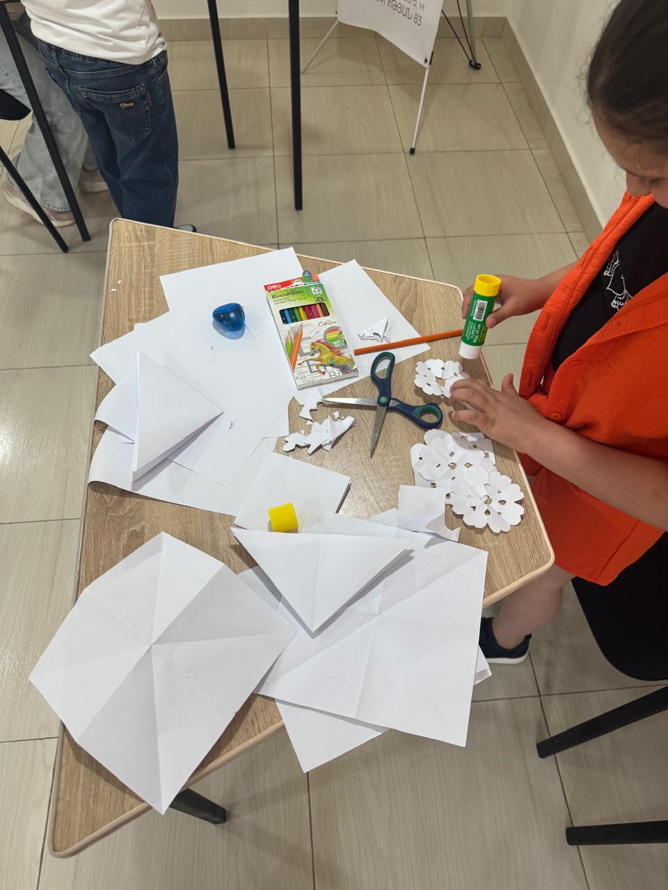 A young participant making paper crafts at the GO Makerspace